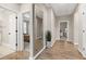 Hallway with wood floors, a large mirror, and views into adjacent rooms at 213 W Weatherford Dr, Angier, NC 27501