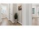 Hallway with a view of the bathroom, living room, hardwood floors, and plant at 213 W Weatherford Dr, Angier, NC 27501