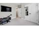 Home gym area complete with TV and exercise equipment adjacent to hall, and closet with mirrored doors at 213 W Weatherford Dr, Angier, NC 27501