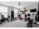 Bright home gym featuring exercise equipment, a weight rack, and natural light from large windows at 213 W Weatherford Dr, Angier, NC 27501
