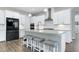 Kitchen island with seating, stainless appliances and modern lighting at 213 W Weatherford Dr, Angier, NC 27501