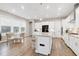 Bright, modern kitchen with white cabinets, stainless steel appliances, and a center island at 213 W Weatherford Dr, Angier, NC 27501