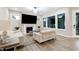 Cozy living room with a fireplace, large windows, and comfortable seating at 213 W Weatherford Dr, Angier, NC 27501