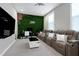 Spacious living room with a moss wall feature, comfortable seating, and a modern entertainment setup at 213 W Weatherford Dr, Angier, NC 27501