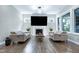 Bright living room with fireplace, large screen television and contemporary furnishings at 213 W Weatherford Dr, Angier, NC 27501