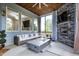Comfortable screened in porch with a stone fireplace, tv, and modern furniture at 213 W Weatherford Dr, Angier, NC 27501
