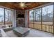 Cozy screened porch with a brick fireplace, comfortable seating, and wooded views at 213 W Weatherford Dr, Angier, NC 27501