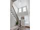 Elegant staircase with a chandelier, large windows, and stylish railing at 213 W Weatherford Dr, Angier, NC 27501