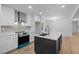 Open kitchen featuring an island, stainless steel appliances, and white cabinets for a clean design at 2224 Clements Dr, Durham, NC 27704