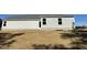 Side and backyard view of a white home with a grassy area at 223 Magnolia Run Way, Benson, NC 27504
