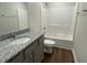 A full bath featuring a granite vanity and shower-tub combo at 223 Magnolia Run Way, Benson, NC 27504