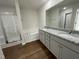 Well-lit bathroom with a double vanity, granite countertops, and separate shower and tub at 223 Magnolia Run Way, Benson, NC 27504
