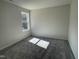 Empty bedroom with neutral walls, carpet, and a window letting in natural light at 223 Magnolia Run Way, Benson, NC 27504