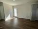 Bedroom features wood flooring and patio door for access to the backyard at 223 Magnolia Run Way, Benson, NC 27504