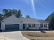 Charming single-story home featuring a gray exterior and a well-manicured front yard at 223 Magnolia Run Way, Benson, NC 27504