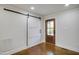 Bright entryway features a sliding barn door, a striking wood-framed front door, and hardwood floors at 226 Pinecroft Dr, Raleigh, NC 27609