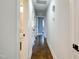 Hallway with hardwood floors and white trim leading to other rooms in the house at 226 Pinecroft Dr, Raleigh, NC 27609