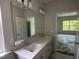 Bathroom featuring double sinks, modern fixtures, and a large mirror at 235 Meadowbark Bnd # 26, Garner, NC 27529