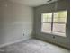 Unfinished bedroom with a bright window and a beautiful view of the outdoors at 235 Meadowbark Bnd # 26, Garner, NC 27529