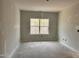 Unfinished bedroom featuring a bright window and neutral walls at 235 Meadowbark Bnd # 26, Garner, NC 27529