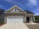 Charming single-story home featuring stone accents, a two-car garage, and a well-manicured front yard at 235 Meadowbark Bnd # 26, Garner, NC 27529