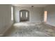 Spacious living room with an arched doorway leading to the entryway in an unfinished home at 235 Meadowbark Bnd # 26, Garner, NC 27529