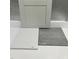 Material samples featuring a gray cabinet door, white quartz countertop, and gray tile flooring at 235 Meadowbark Bnd # 26, Garner, NC 27529
