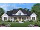 Beautiful home exterior with manicured lawn, covered porch, and stylish black and white color scheme, giving it modern curb appeal at 2600 Banks Rd # 1, Raleigh, NC 27603