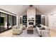 Inviting living room featuring a stone fireplace, built-in bookshelves, and comfortable seating with view to outdoor fireplace at 2600 Banks Rd # 1, Raleigh, NC 27603