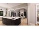 Open-concept space blending kitchen and living areas, showcasing a fireplace, built-ins, island, and modern lighting at 2600 Banks Rd # 1, Raleigh, NC 27603