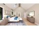 Spacious main bedroom with vaulted ceilings, a skylight, hardwood floors, and abundant natural light at 2600 Banks Rd # 1, Raleigh, NC 27603