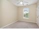 Cozy bedroom featuring neutral carpet, cream walls, a window and ceiling fan at 3009 Winston Dr # 90, Burlington, NC 27215