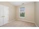 A bedroom with a neutral carpet, cream-colored walls and a window for natural light at 3009 Winston Dr # 90, Burlington, NC 27215