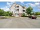 Condo building exterior featuring private balconies and ample parking at 3009 Winston Dr # 90, Burlington, NC 27215