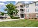 Corner of condo building shows multiple levels with stone accents, surrounded by lush greenery at 3009 Winston Dr # 90, Burlington, NC 27215