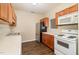 Functional kitchen equipped with stainless steel refrigerator and white appliances at 3009 Winston Dr # 90, Burlington, NC 27215