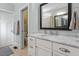 Bathroom features a white vanity with a marble countertop and a framed mirror at 312 Bickett Blvd, Raleigh, NC 27608