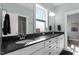 A bathroom with a double sink vanity, granite counters and a large framed mirror at 312 Bickett Blvd, Raleigh, NC 27608