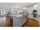 Spacious kitchen featuring white cabinets, an island with a wine fridge, and modern appliances at 312 Bickett Blvd, Raleigh, NC 27608