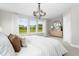 Comfortable main bedroom with a stylish light fixture, multiple windows, and warm decor at 341 Church St # 67, Wendell, NC 27591
