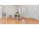 Bright dining area featuring a round wooden table and chairs, complemented by laminate floors and a window at 4082 Old Franklinton Rd, Franklinton, NC 27525