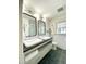 Bright bathroom with double sinks, black countertops, and hexagon floor tiles at 419 Second St, Apex, NC 27502