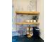 Decorated kitchen with open wood shelving and a geometric backsplash at 419 Second St, Apex, NC 27502