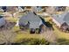 Bird's eye view of a brick home with manicured lawns and a screened porch in a residential neighborhood at 4270 Aviemore Run, Burlington, NC 27215