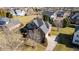 Aerial view of a brick home on a spacious lot with mature trees and well-maintained landscaping at 4270 Aviemore Run, Burlington, NC 27215