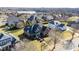 Aerial view of a meticulously landscaped home with a manicured lawn and mature trees in a suburban setting at 4270 Aviemore Run, Burlington, NC 27215