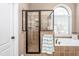 Modern bathroom featuring a glass-enclosed shower, soaking tub with tile surround, and neutral color palette at 4270 Aviemore Run, Burlington, NC 27215