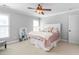 Bedroom showcasing a comfortable bed, a ceiling fan, natural light, and soothing grey walls at 4270 Aviemore Run, Burlington, NC 27215