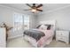 Bedroom offers a cozy bed, a fan, and neutral tones perfect for relaxation at 4270 Aviemore Run, Burlington, NC 27215