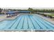 Large community pool with lap lanes, sun loungers, and shaded seating areas for relaxation at 4270 Aviemore Run, Burlington, NC 27215